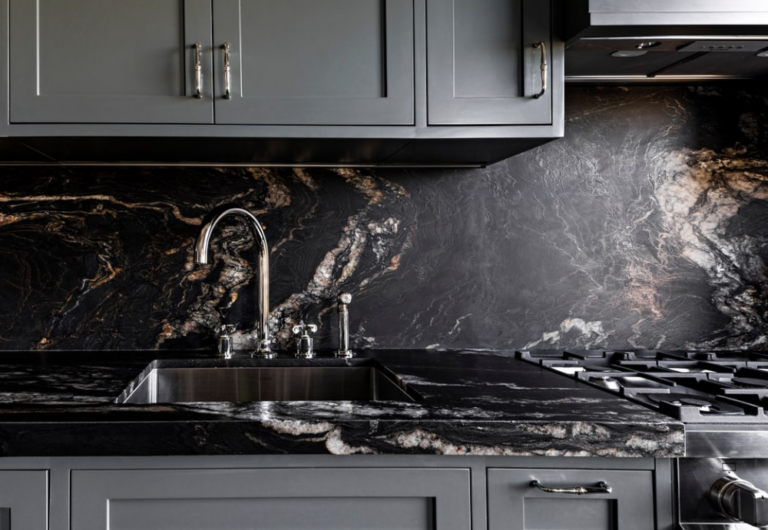 A stainless steel sink set in a stone countertop