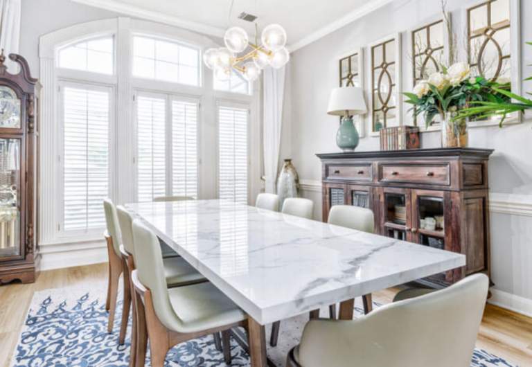 A porcelain countertop in an elegant dining room with a blue carpet and large window